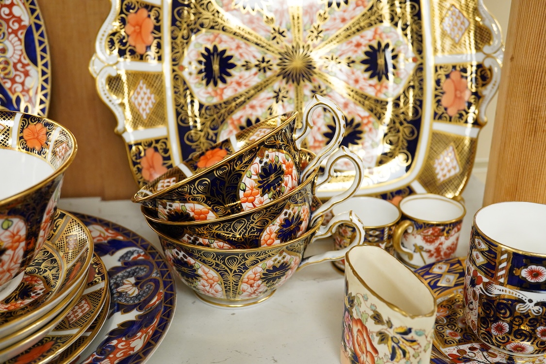 A quantity of Royal Crown Derby Imari to include a sandwich plate, cups and saucers and and miniature twin handled cups, largest 27cm in diameter